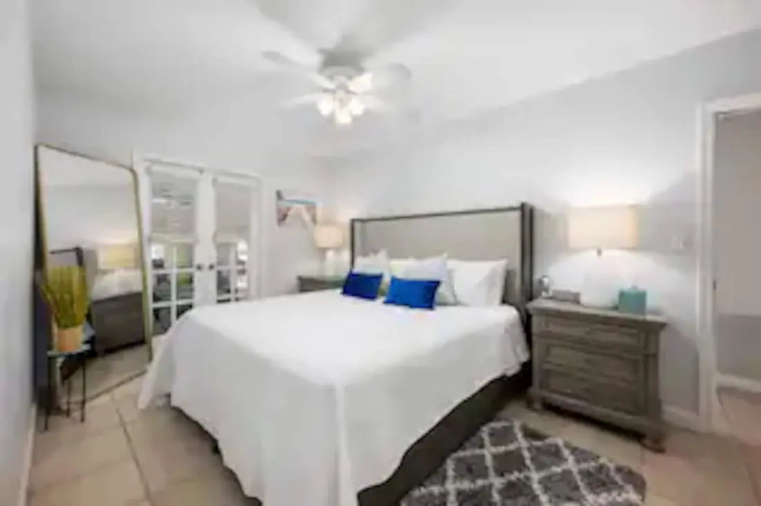 Bedroom with a king bed and blue accent pillows