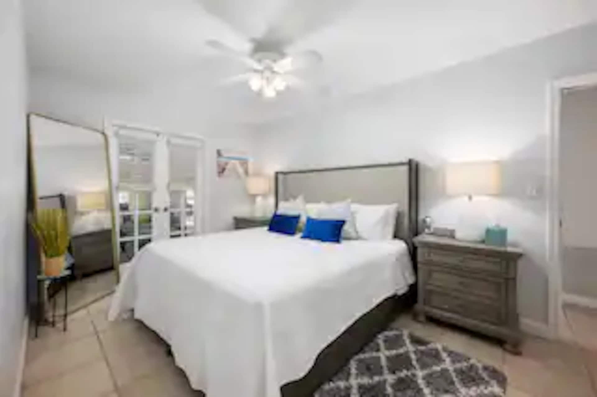 A bright bedroom with a queen bed
