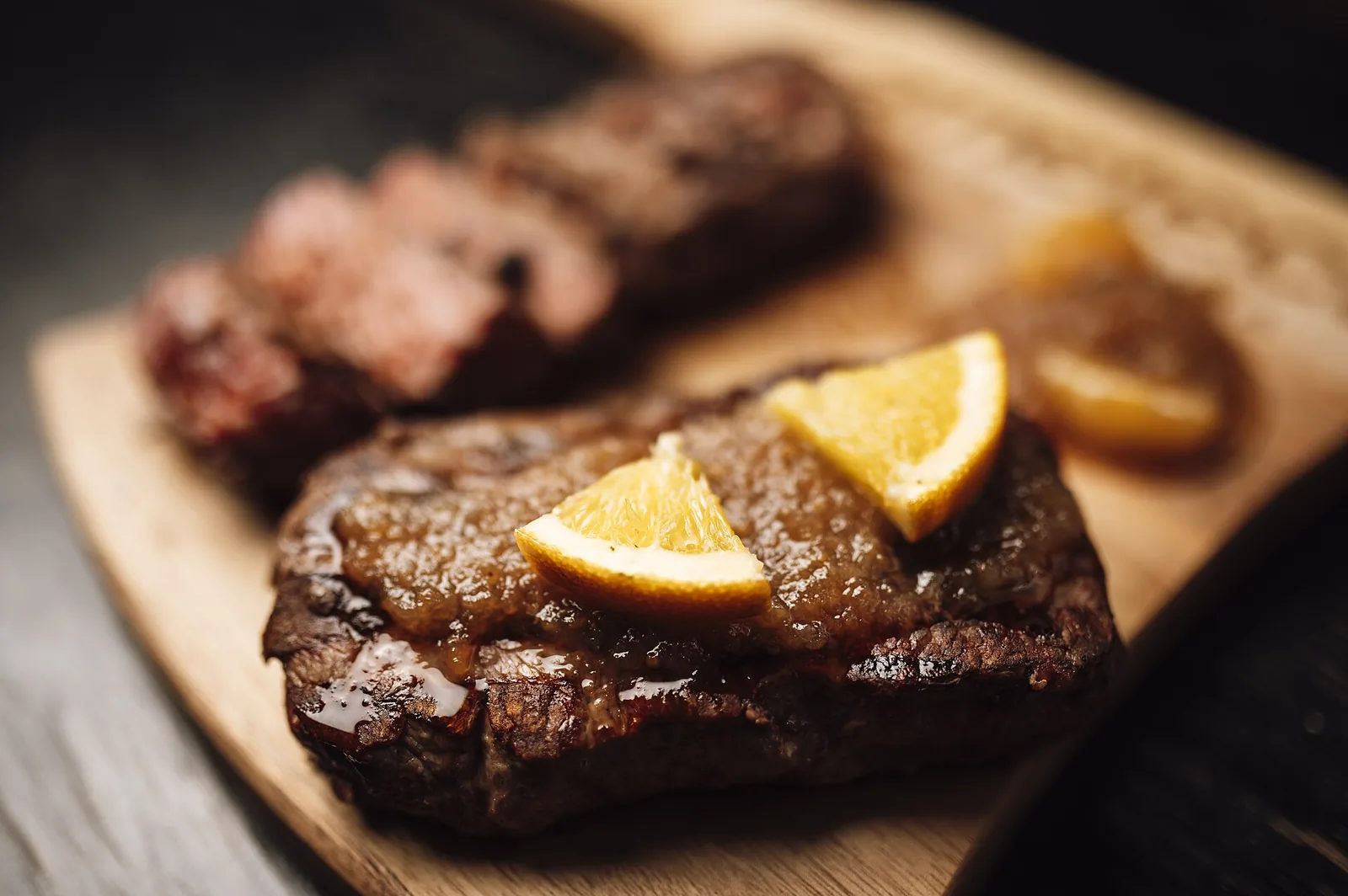 A grilled steak served on a wooden board