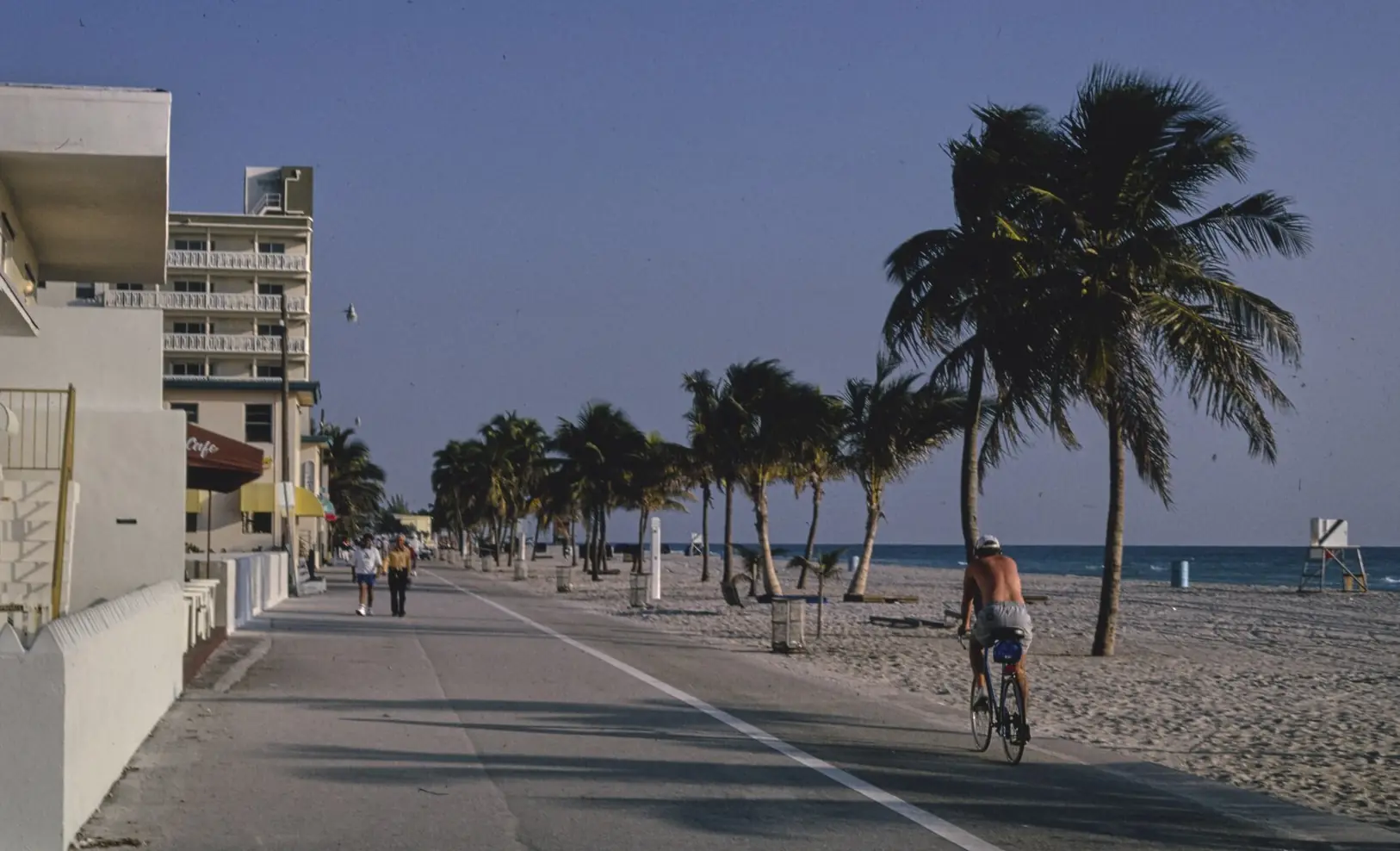 People walking and cycling on the Broadwalk at Hollywood Beach, Florida