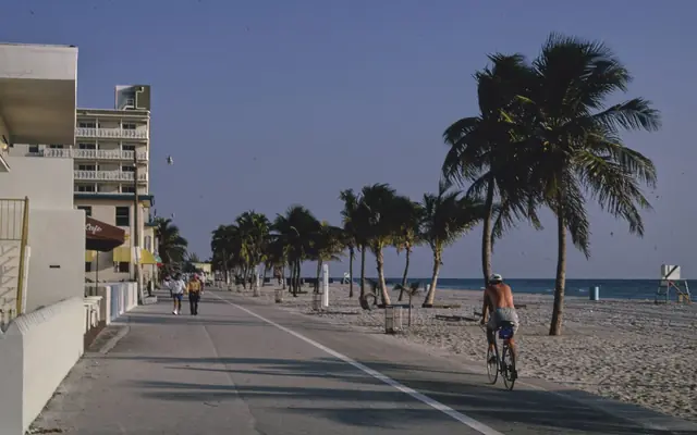 People walking and cycling on the Broadwalk at Hollywood Beach, Florida