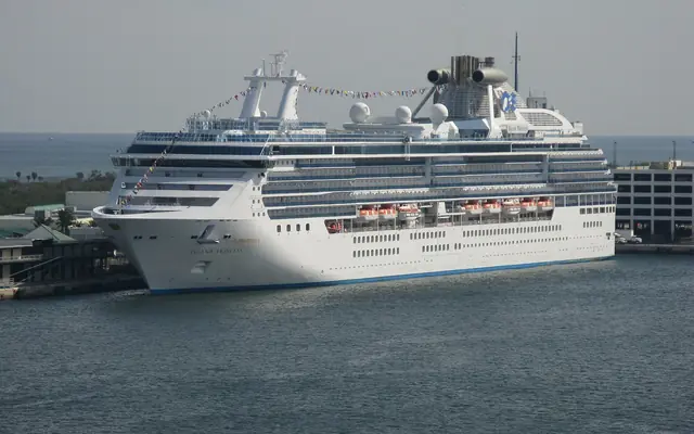 Port Everglades: a large Princess Cruises ship, the Island Princess, berthed at a port terminal with flat coastline in the background