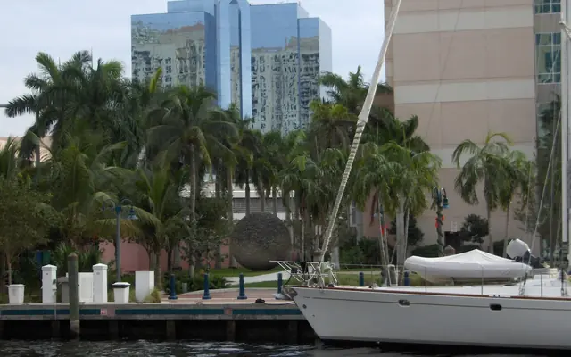 Jungle Queen Riverboat: a boat docked along the New River in downtown Fort Lauderdale, with the Riverwalk, palm trees, and modern glass high-rises in the background
