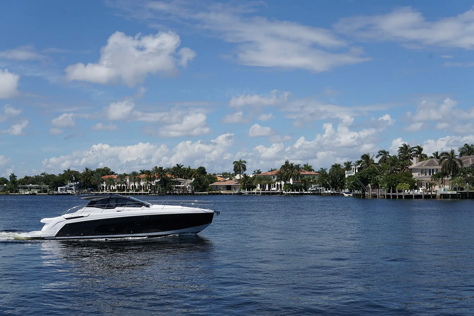 A motor yacht cruising the Intracoastal Waterway past waterfront homes in Fort Lauderdale