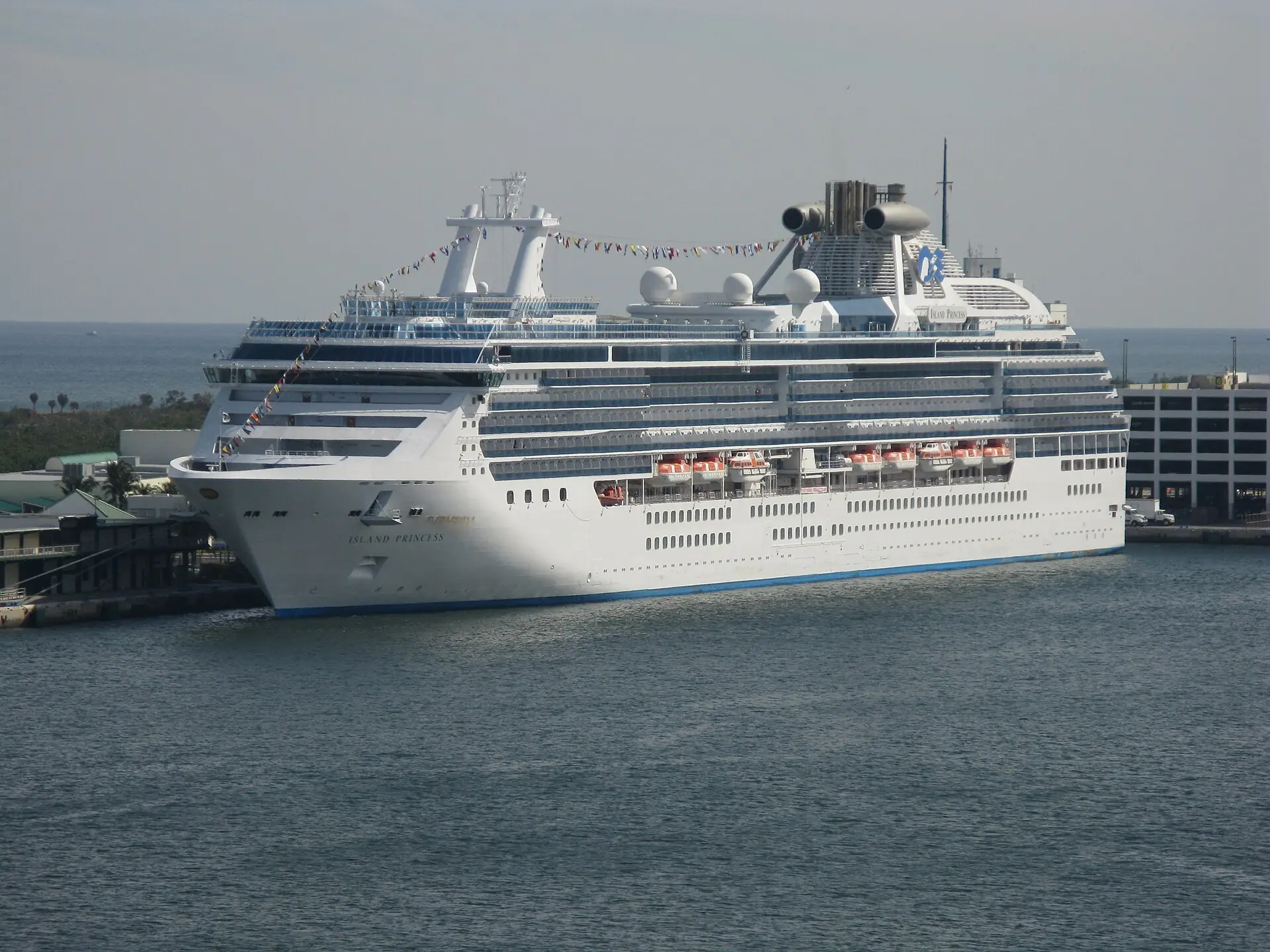 Port Everglades: a large Princess Cruises ship, the Island Princess, berthed at a port terminal with flat coastline in the background