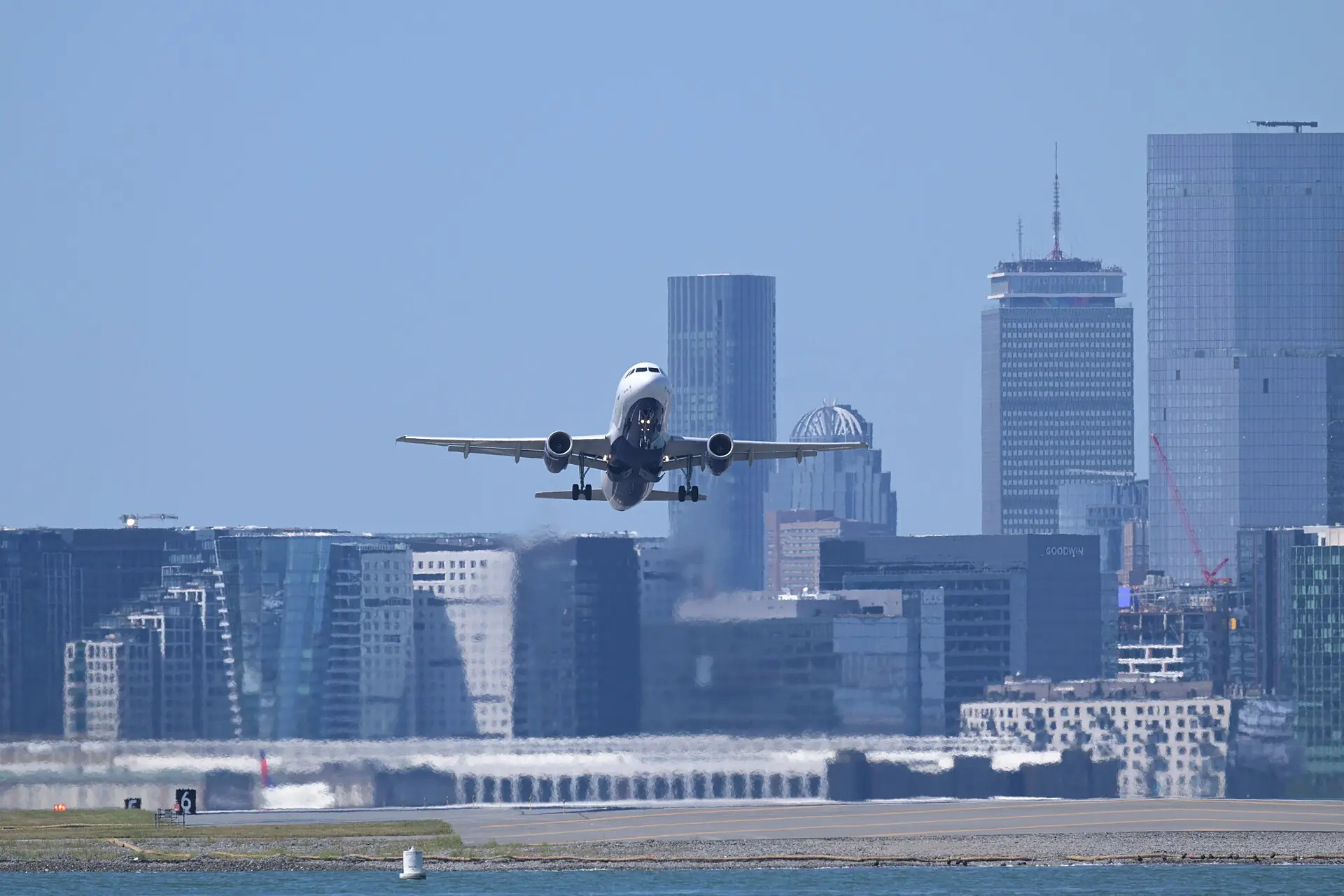 A JetBlue Airbus A320 departing Boston Logan with the Boston skyline behind
