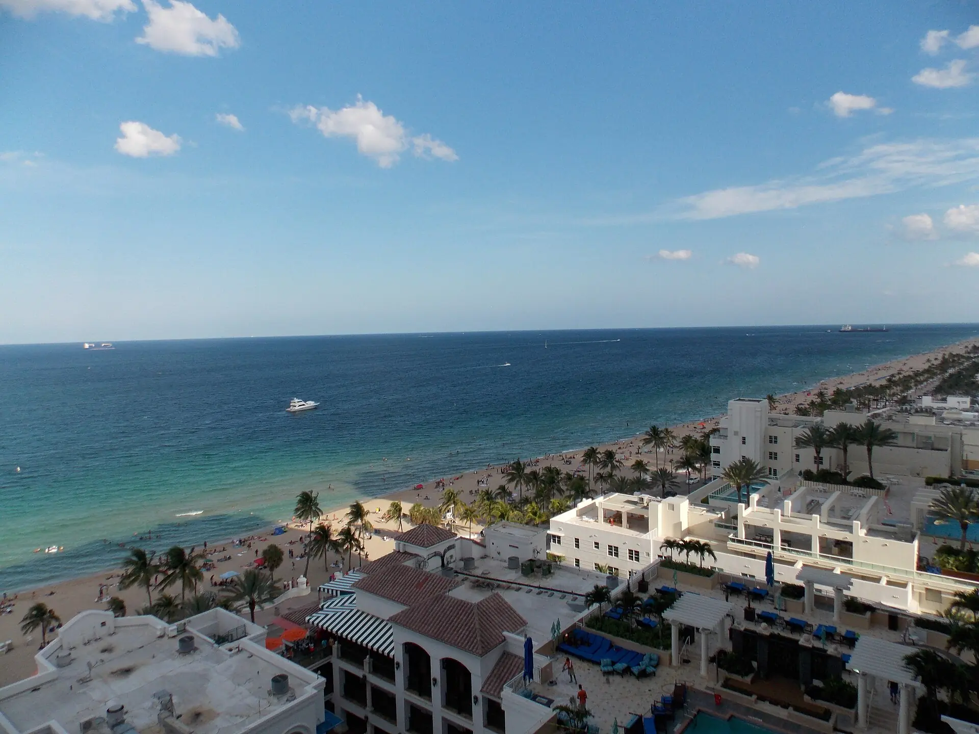 Las Olas Boulevard: elevated view from a high-rise overlooking beachfront resort rooftops, Fort Lauderdale beach, and the Atlantic Ocean