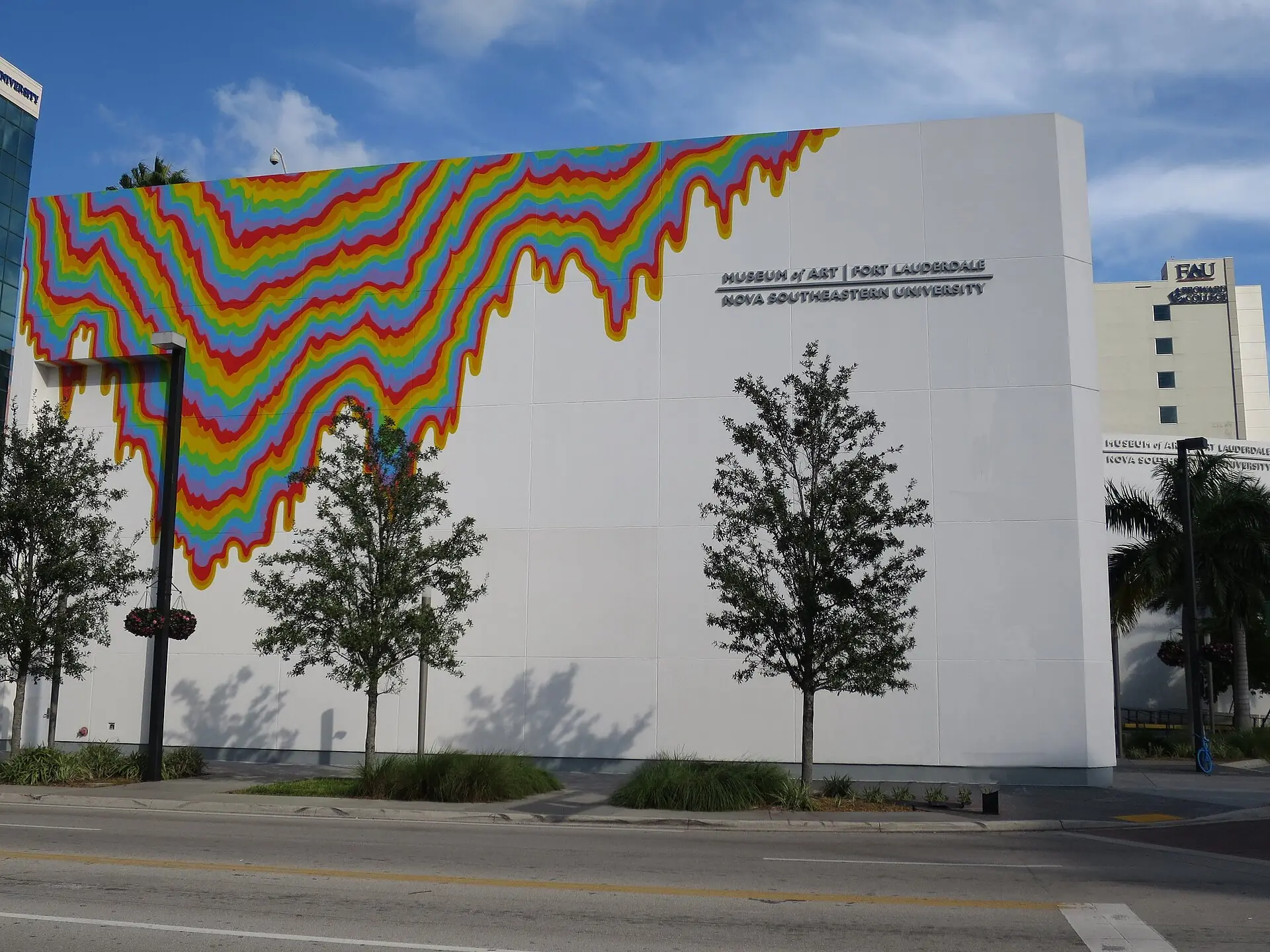 Exterior of the NSU Art Museum Fort Lauderdale building featuring a colorful dripping rainbow mural on its white modernist wall