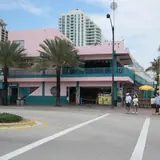 Exterior of the iconic pink-and-teal Elbo Room bar on Fort Lauderdale Beach viewed from across the street intersection
