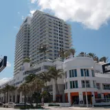 Nube Rooftop: a street-level exterior view of the multi-story Hilton Fort Lauderdale Beach Resort building with palm trees and coastal architecture